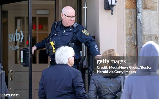 March 10: A Wellesley police officer tells customers that the FDIC has closed the Silicone Valley Bank on March 10, 2023 in Wellesley, Massachusetts