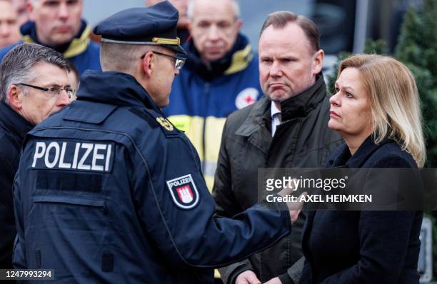German Interior Minister Nancy Faeser reacts as she listens to a police superintendent with Hamburg's Interior Senator Andy Grote at the tatort where...