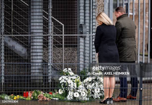 German Interior Minister Nancy Faeser and Hamburg's Interior Senator Andy Grote bow as they look at flowers laying at the tatort where several people...