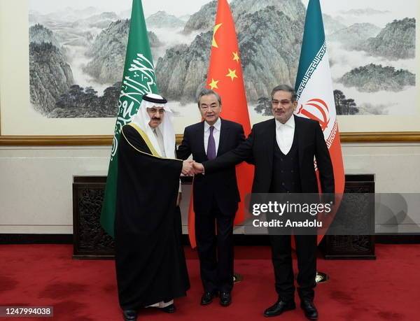 Iran's top security official Ali Shamkhani , Chinese Foreign Minister Wang Yi and Musaid Al Aiban, the Saudi Arabia's national security adviser pose...