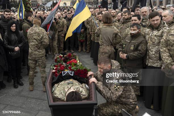 Image depicts death.) Valerii Zaluzhnyi, commander-in-chief of the Armed Forces of Ukraine, bottom right, pays his respects at the funeral of fallen...