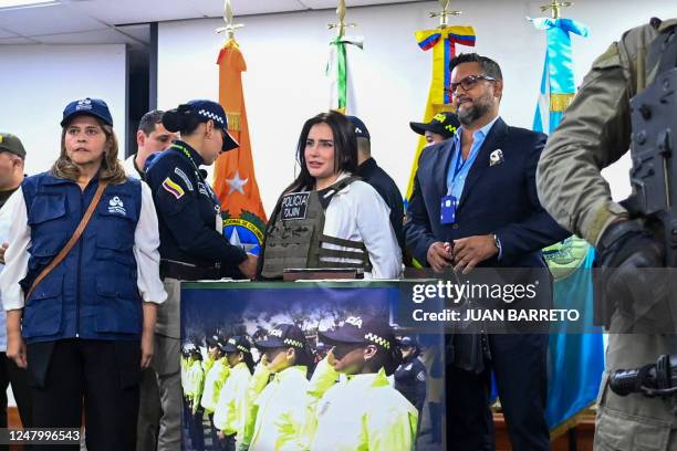 Colombian former Senator Aida Merlano is escorted by the police on her arrival to the Directorate of Criminal Investigation and Interpol office in...