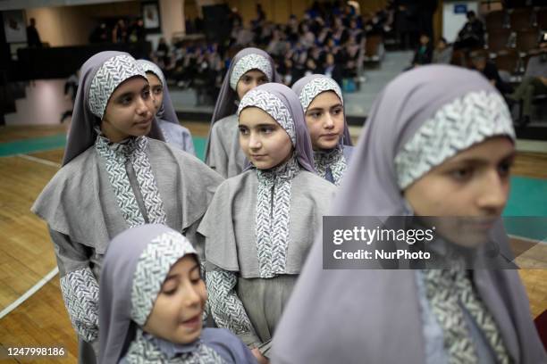 Iranian schoolgirls wait to perform in an opening ceremony of the First International Nowruz Games for Women, at a basketball hall in Azadi sport...