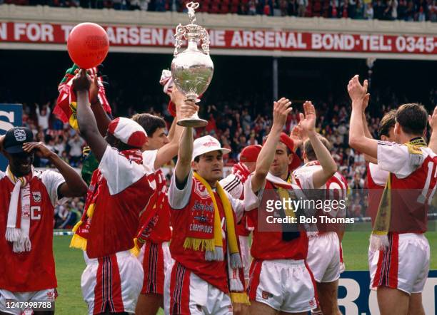 Arsenal players including Anders Limpar celebrate with the League Championship trophy after the final Barclays League Division One match of the...