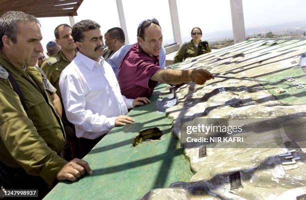 Israeli Defence Minister Amir Peretz listens on with General Kaplisnki as Beni Teresa , a contraction engineer working on the controversial...