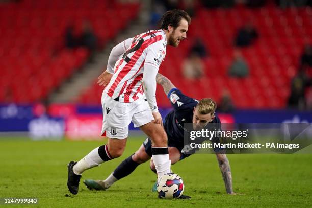 Stoke City's Gavin Kilkenny battles with Blackburn Rovers' Sammie Szmodics during the Sky Bet Championship match at the bet365 Stadium,...