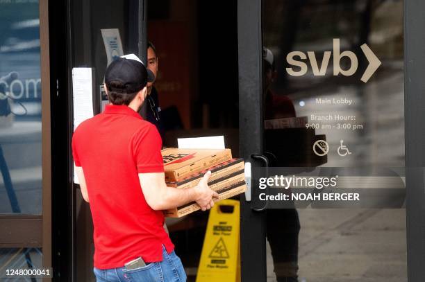 Delivery person drops off pizzas at Silicon Valley Banks headquarters in Santa Clara, California on March 10, 2023. - US authorities swooped in and...