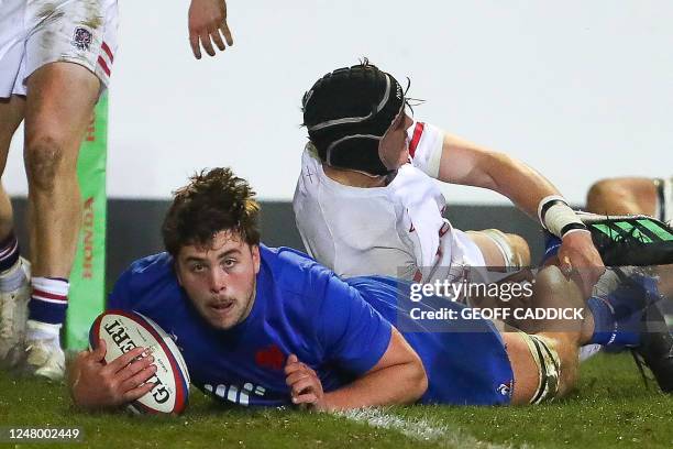 France's Cyriac Guilly dives over the line to score a try during the Six Nations U20 rugby union match between England and France at the Recreation...