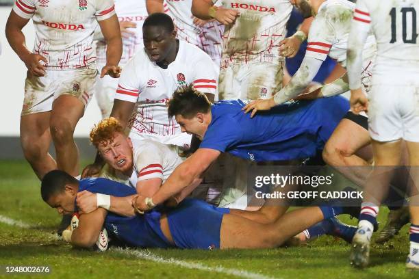 France's prop Louis Penverne dives over the line to score a try during the Six Nations U20 rugby union match between England and France at the...