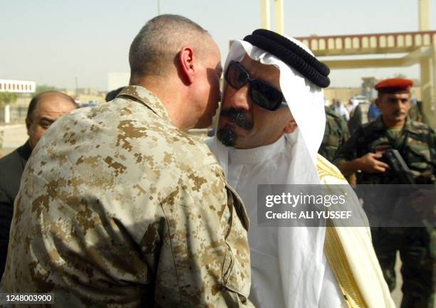 Iraqi tribal leader Sheikh Sattar Abu Risha is given a welcoming embrace by Brigadier General John Allen , Deputy Commander, U.S. Forces in Anbar...