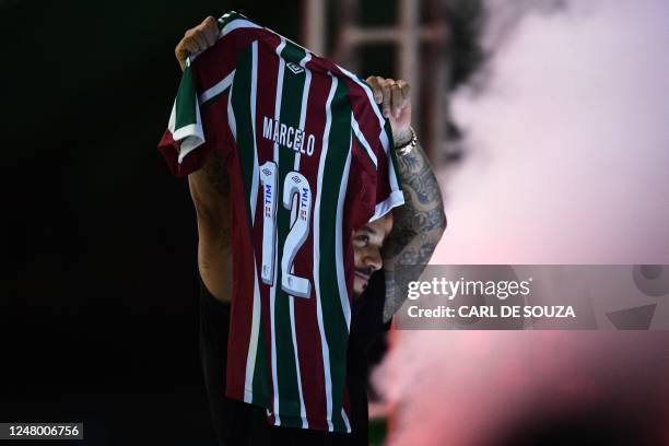 Brazilian defender Marcelo shows his shirt during his official presentation as Fluminense's new player at the Maracana stadium in Rio de Janeiro,...