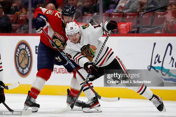 Eric Staal of the Florida Panthers crosses sticks with Joey Anderson of the Chicago Blackhawks at the FLA Live Arena on March 10, 2023 in Sunrise,...