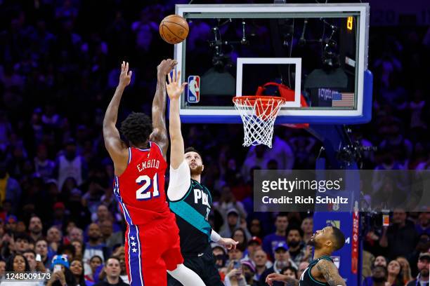 Joel Embiid of the Philadelphia 76ers takes the winning shot with 1.1 seconds remaining as Jusuf Nurkic of the Portland Trail Blazers defends during...