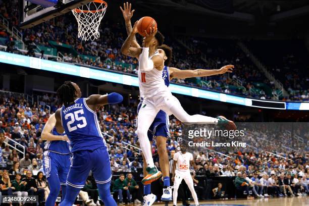 Jordan Miller of the Miami Hurricanes goes to the basket against Dereck Lively II of the Duke Blue Devils during the second half in the semifinals of...