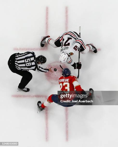 Linesman Ryan Gibbons drops the puck between Cole Guttman of the Chicago Blackhawks and Carter Verhaeghe of the Florida Panthers during the first...