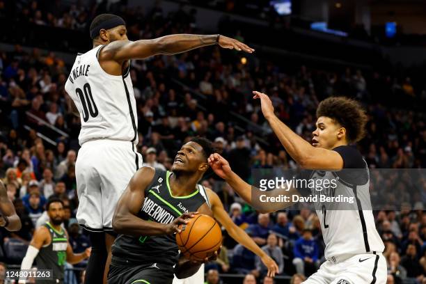 Anthony Edwards of the Minnesota Timberwolves goes to the basket while Cameron Johnson and Royce O'Neale of the Brooklyn Nets defend in the fourth...