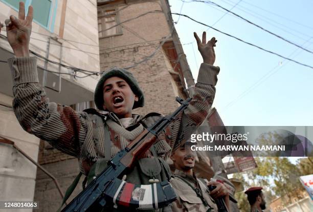 Yemeni dissident soldiers salute pro-reform protesters as they march in Sanaa October 25, 2011 before government troops opened fire on them during a...