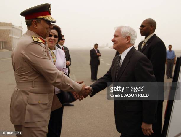 Defence Secretary Robert Gates shakes hands with Egypt's Major General Hassan el-Roweini upon his arrival at Cairo international airport on May 4,...