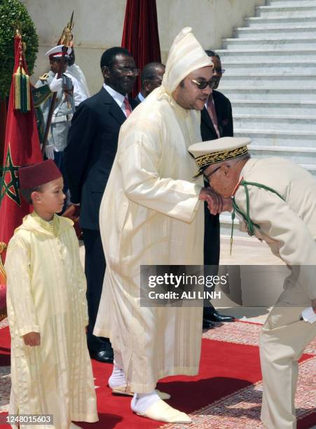 Morocco's King Mohammed VI flanked by his son Prince Moulay Hassan receives tribute from General Mimoun , chief of Moroccan Royal Guard in Tangier on...