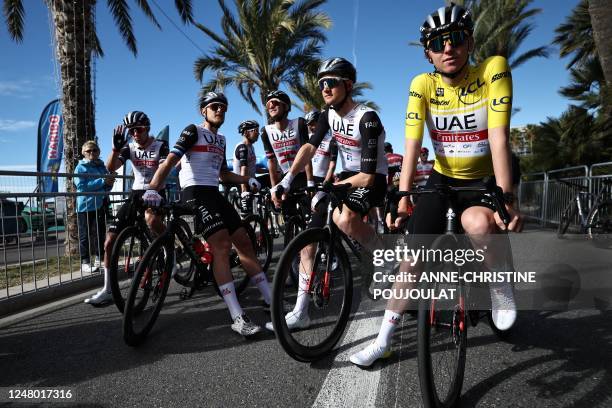 Team Emirates' riders, including UAE Team Emirates' Slovenian rider Tadej Pogacar wearing the overall leader's yellow jersey, wait at the "Promenade...