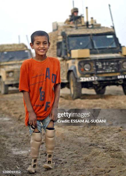 An Iraqi boy shows his artificial legs to British soldiers patrolling the village of Umm al-Rasas located near the Iraqi border with Iran northeast...