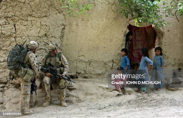Villagers look curious as members of Reconnaissance Platoon, 1st Princess Patricia's Canadian Light Infantry, conduct a foot patrol from a Forward...