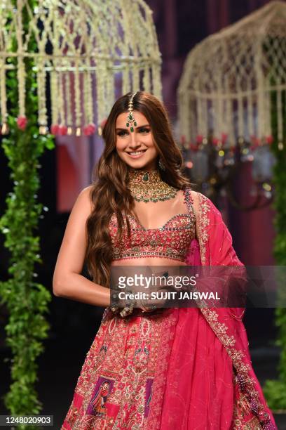 Bollywood actress Tara Sutaria presents a design by Annu's creation during the Lakmé Fashion Week x FDCI, in Mumbai on March 11, 2023. / -IMAGE...