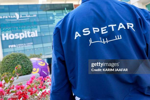 An employee walks outside Aspetar Hospital in Doha on March 11, 2023. - Doctors are still not certain when Brazilian striker Neymar will be able to...