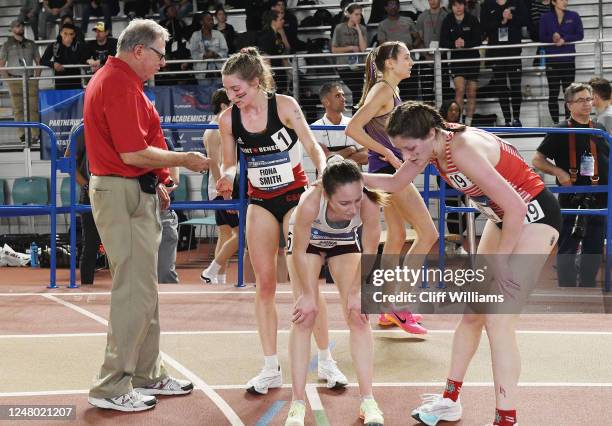 St. Benedicts Fiona Smith, second from left gets the spent round of the starter gun after winning the womens 5,000 meter run during the Division III...