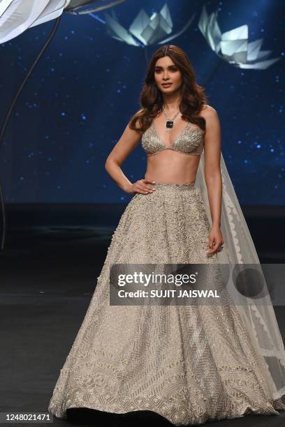 Bollywood actress Diana Penty presents a creation by designer Disha Patil during the Lakmé Fashion Week x FDCI, in Mumbai on March 11, 2023. / -IMAGE...