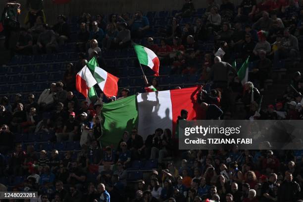 Fans hold and wave the Italian flag prior to the Six Nations international rugby union match between Italy and Wales at the Olympic Stadium in Rome...