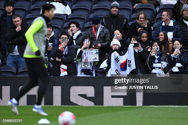 South Korean fans watch Tottenham Hotspur's South Korean striker Son Heung-Min warm up ahead of the English Premier League football match between...