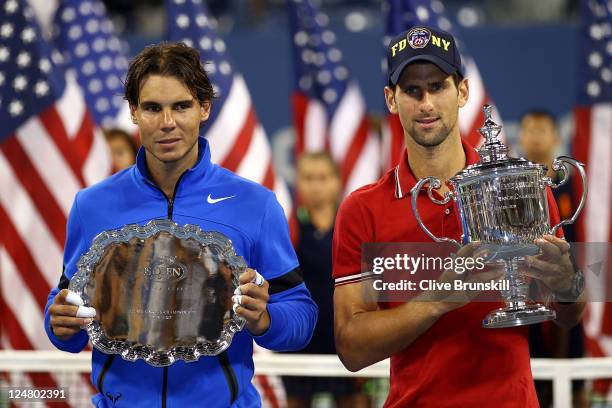 Novak Djokovic of Serbia holds up the winner's the trophy as Rafael Nadal of Spain holds up the runner up award after Djokovic defeated Nadal during...