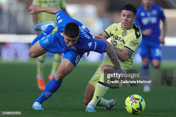 Martín Adrián Satriano of Empoli FC battles for the ball with Nehuen Patricio Perez of Udinese Calcio during the Serie A match between Empoli FC and...