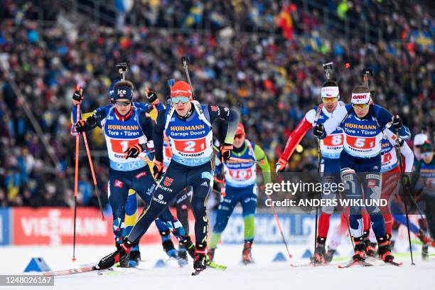 Norway's Endre Strømsheim, Germany's Roman Rees and Finland's Tuomas Harjula compete during the start of the men's 4x7,5 km relay competition of the...