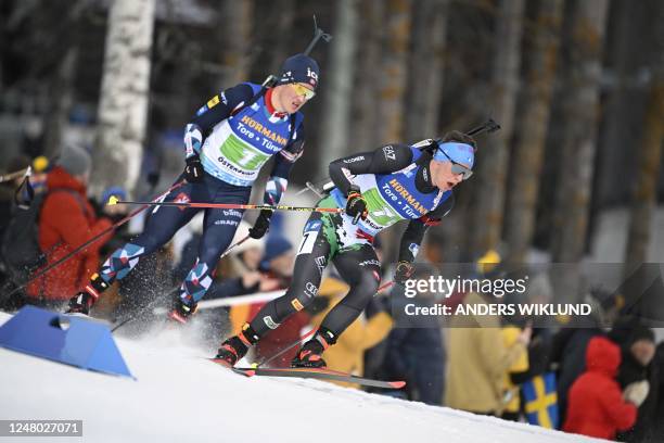 Norway's Endre Stromsheim and Italy's Didier Bionaz compete during the men's 4x7,5 km relay competition during the Biathlon World Cup in Ostersund,...