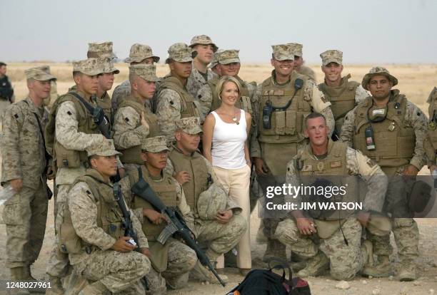 Newly appointed White House Press Secretary Dana Perino poses with US Marines as US President George W. Bush tours Al-Asad Air Base in Anbar...