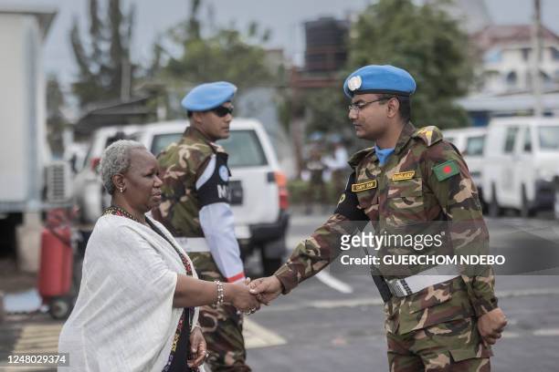 Bintou Keita , the head of the United Nations Organization Stabilization Mission in the Democratic Republic of the Congo , greets a peacekeeper as...