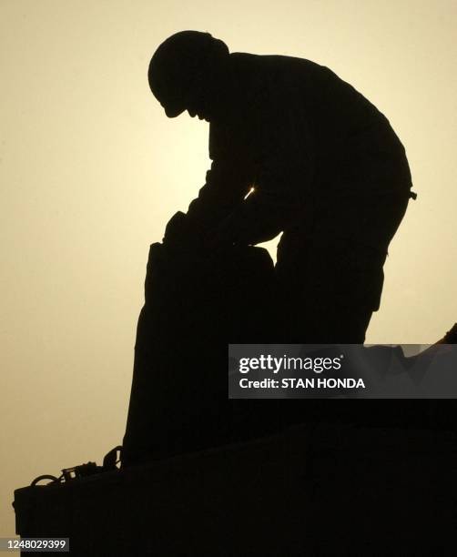 Soldier from the 1-24 Signals Battalion, 4th Infantry Division, packs last minute items on top of a truck 20 February 2004 at a palace of deposed...