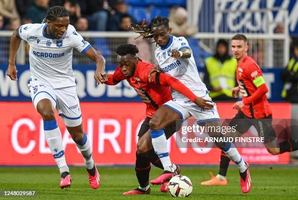 Auxerre's Ghanaian defender Gideon Mensah fights for the ball with Rennes' French forward Arnaud Kalimuendo , during the French L1 football match...