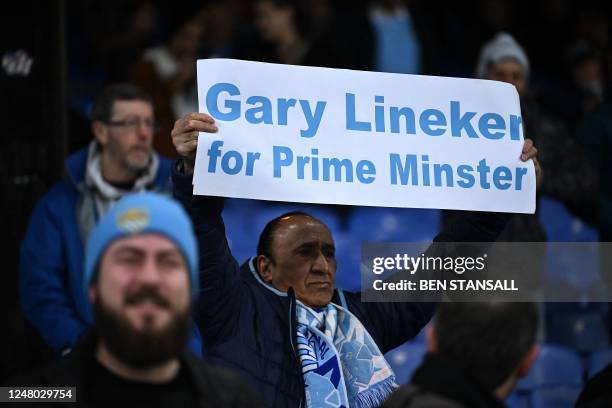 Manchester City fan holds a banner reading "Gary Lineker for Prime Minister" ahead of the English Premier League football match between Crystal...