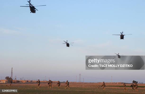Picture released by the US military 11 March 2007 shows US HH-60 Blackhawk helicopters flying over US soldiers with Delta Company, 3-8 CAV, during a...