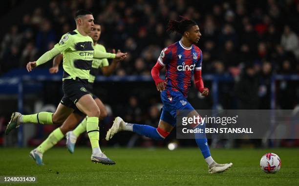 Manchester City's English midfielder Phil Foden chases Crystal Palace's French midfielder Michael Olise during the English Premier League football...