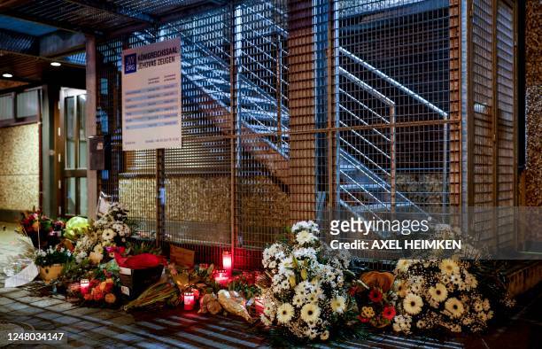 Flowers and candles are seen on March 11, 2023 in Hamburg, northern Germany, at the tatort where several people were killed in a shooting in a church...