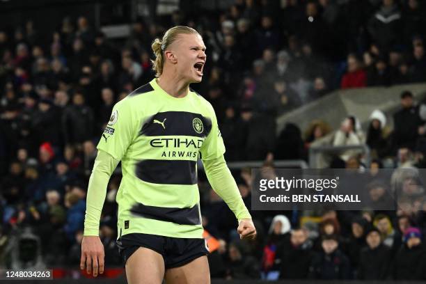 Manchester City's Norwegian striker Erling Haaland celebrates after scoring the opening goal from the penalty spot during the English Premier League...