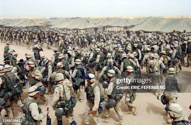 Marines from the 2nd battalion/8 MAR, prepare themselves after receiving orders to cross the Iraqi border at Camp Shoup, northern Kuwait, 20 March...