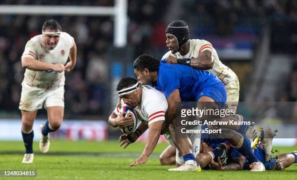 Englands Mako Vunipola is tackled by Frances Peato Mauvaka as England's Maro Itoje piles in on top during the Six Nations Rugby match between England...