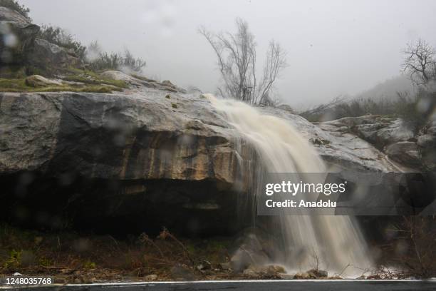 View of waterfall as snow melted from the mountain on Highway 190 during heavy rain in Springville, California on March 11, 2023 as atmospheric river...