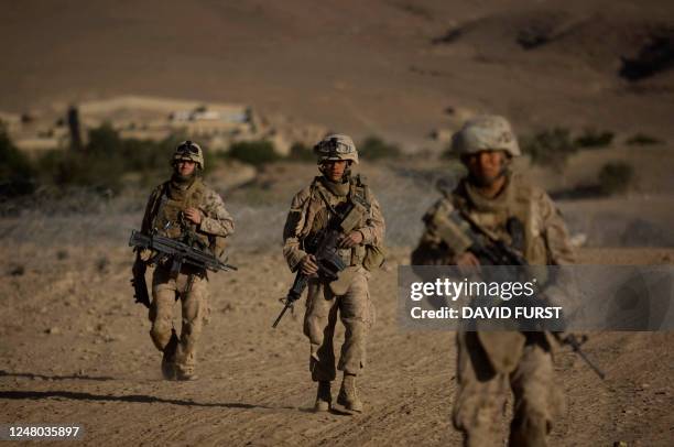 Marines from Fox Company 2nd Battalion 3rd Marines patrol on the outskirts of their forward operating base, in Farah Province, southern Afghanistan,...