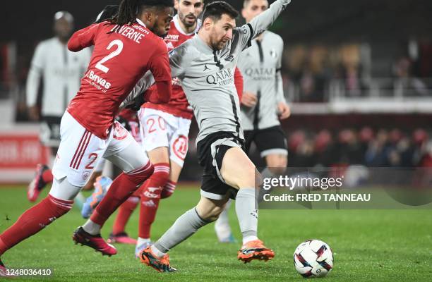 Brest's French defender Jean-Kevin Duverne fights for the ball with Paris Saint-Germain's Argentine forward Lionel Messi during the French L1...